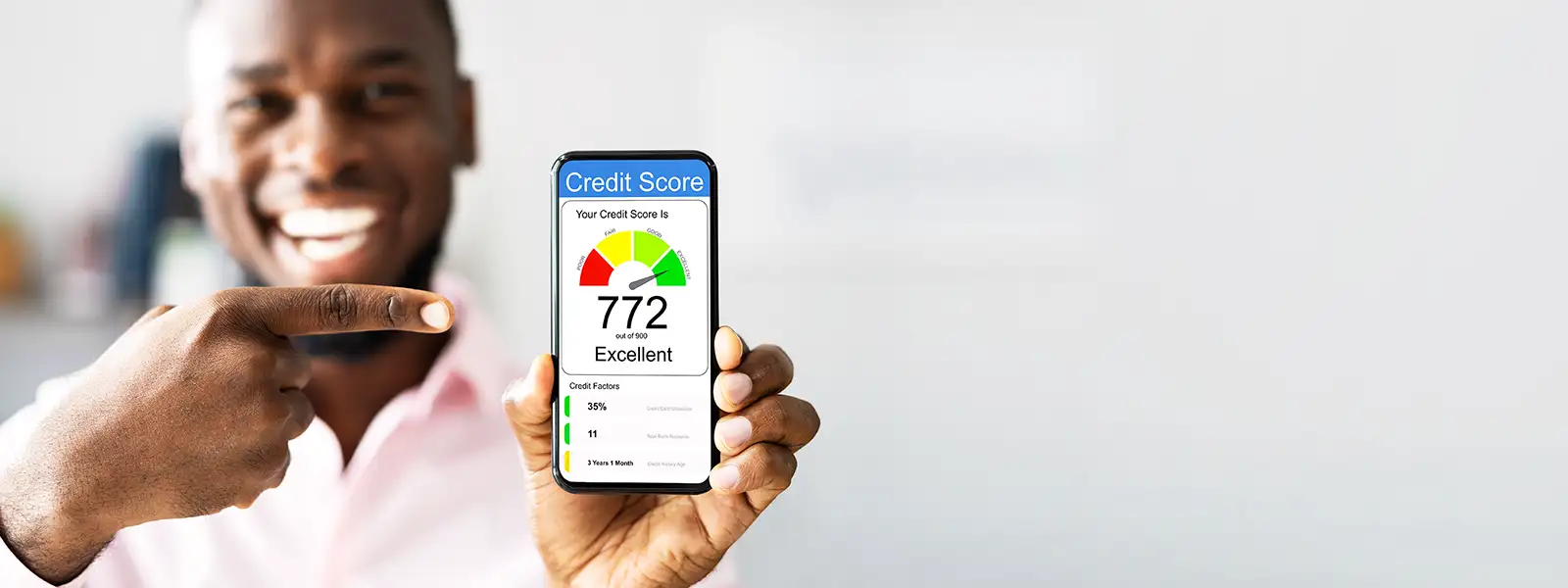 Smiling Man Holding Phone Showing Credit Score